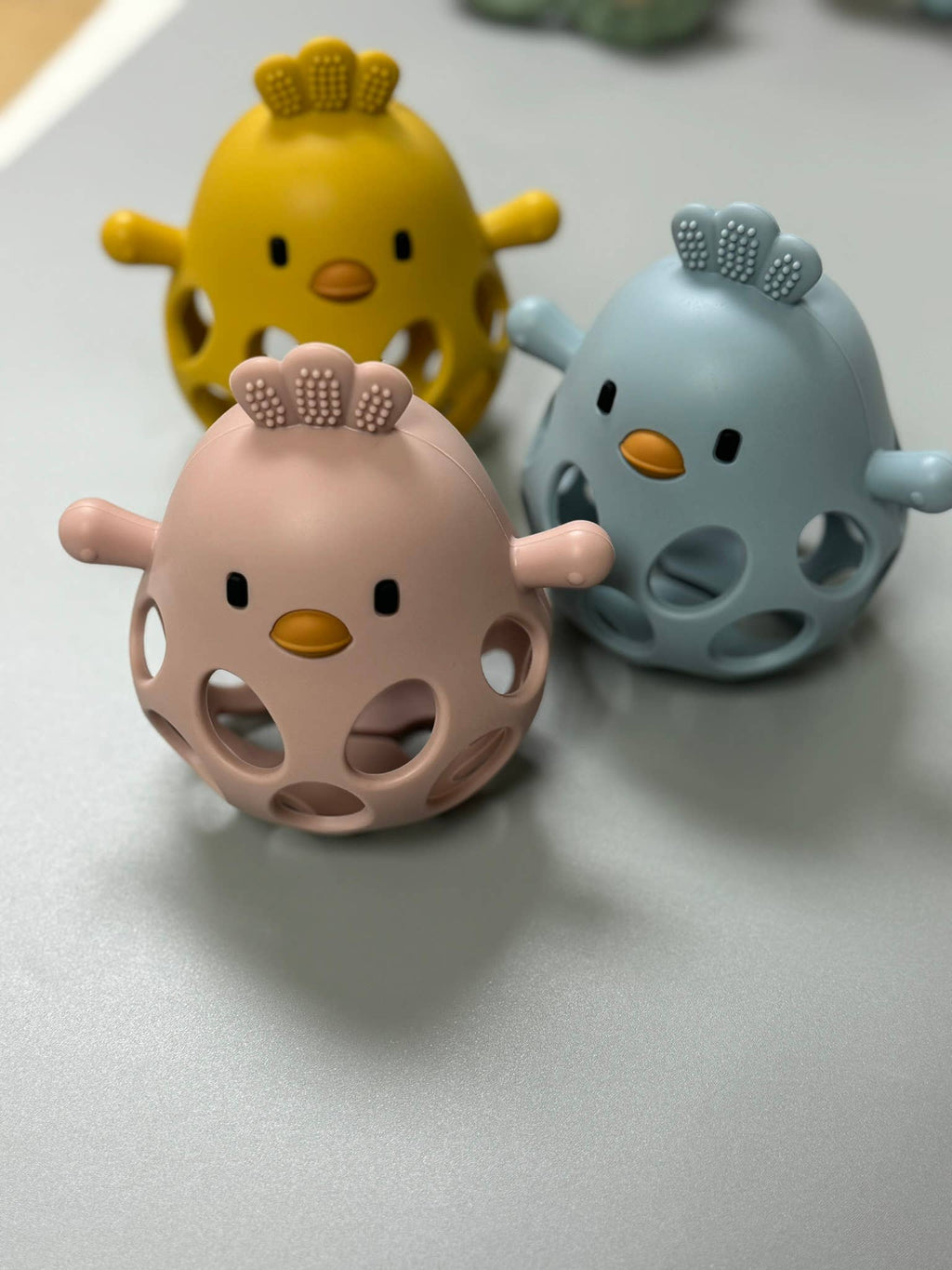 A playful 3D chicken teether made from soft silicone for soothing sore gums and curious little hands.