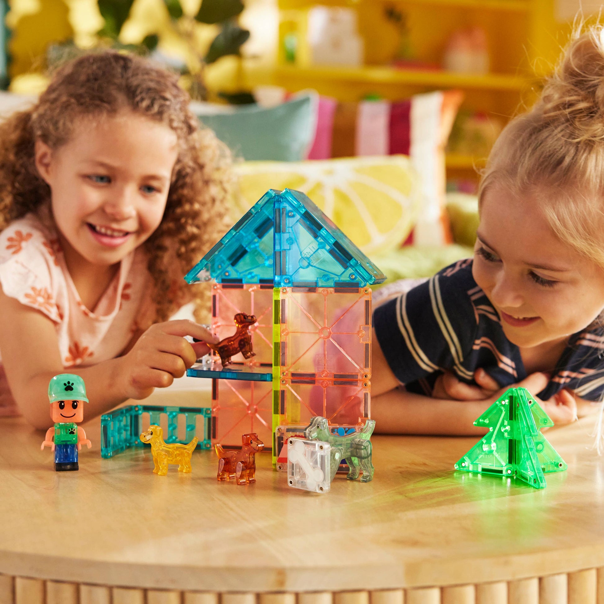 Girls and boys playing with MAGNA-TILES® Puppy Park – 27-Piece Magnetic Building Set