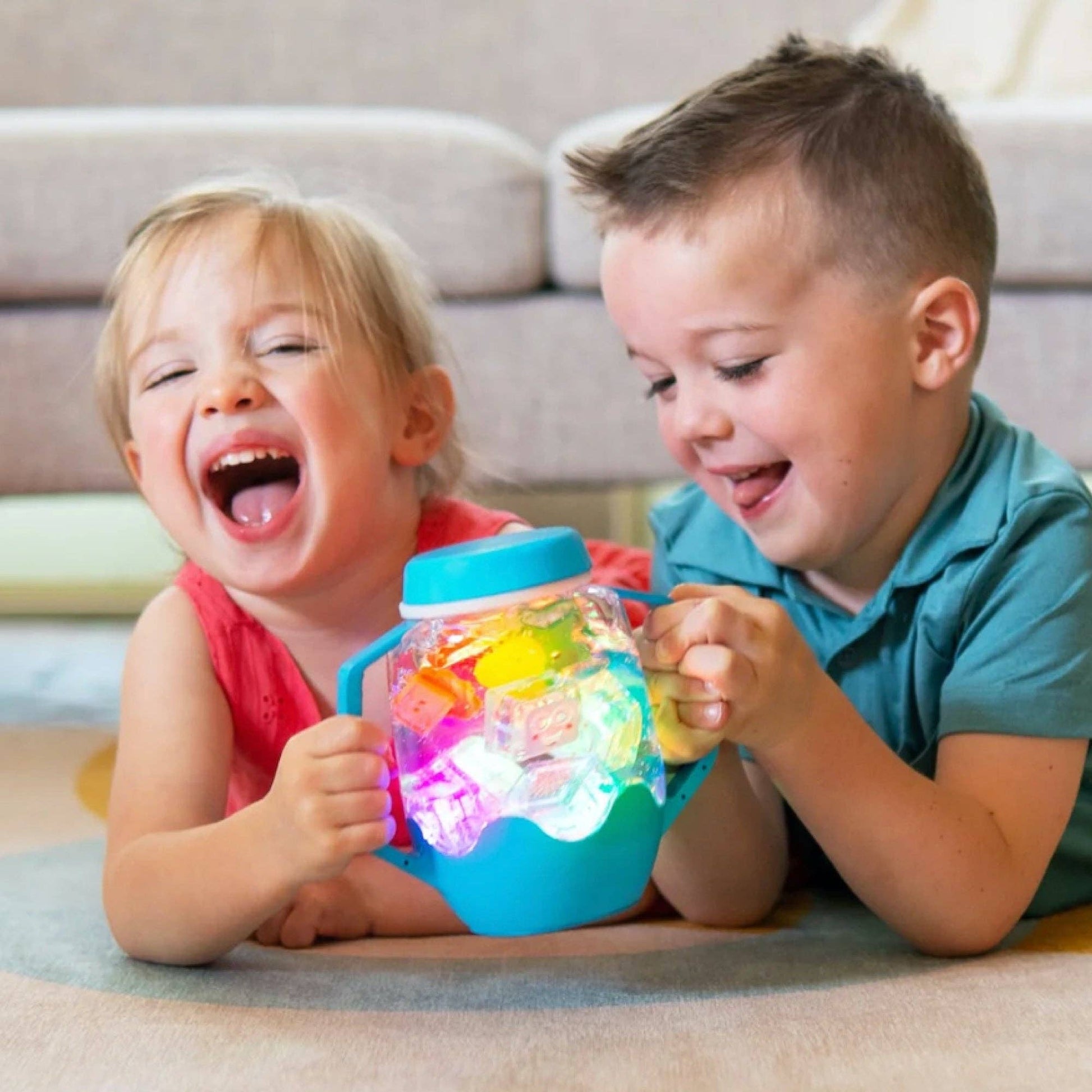 Toddler using blue sensory play jar with glowing lights